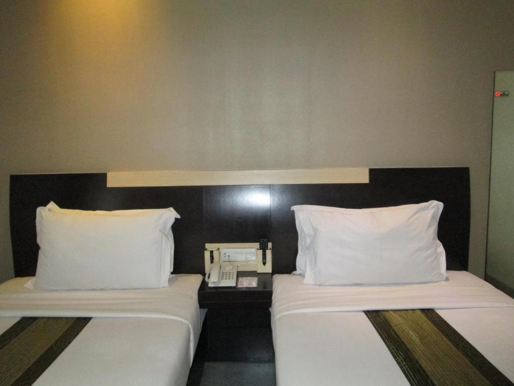 Postel nebo postele na pokoji v ubytování Vio Hotel Cimanuk Bandung