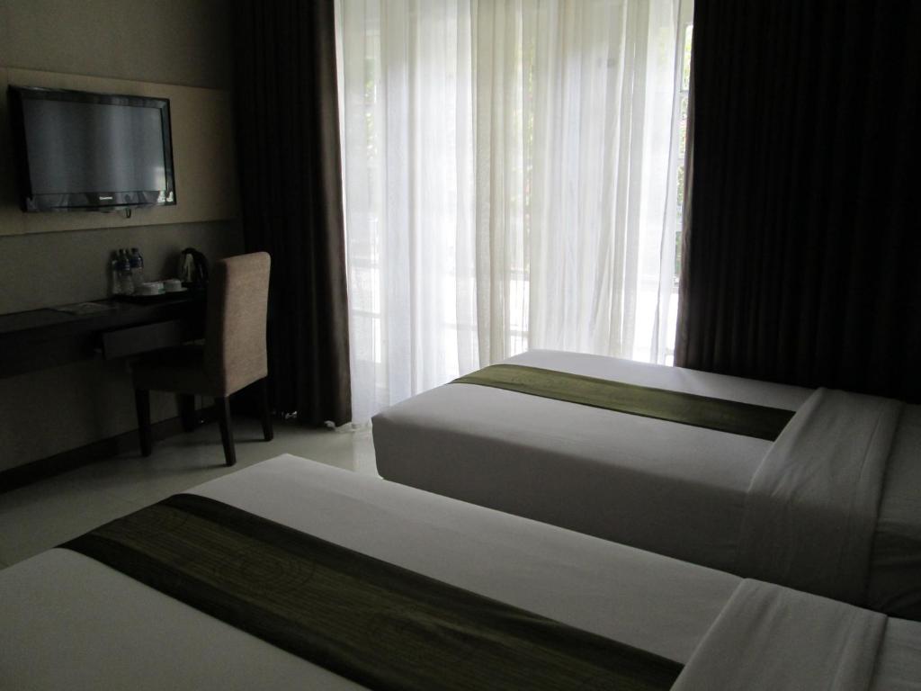 Postel nebo postele na pokoji v ubytování Vio Hotel Cimanuk Bandung