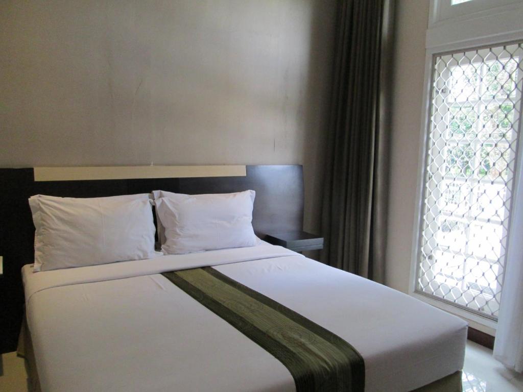 Postel nebo postele na pokoji v ubytování Vio Hotel Cimanuk Bandung