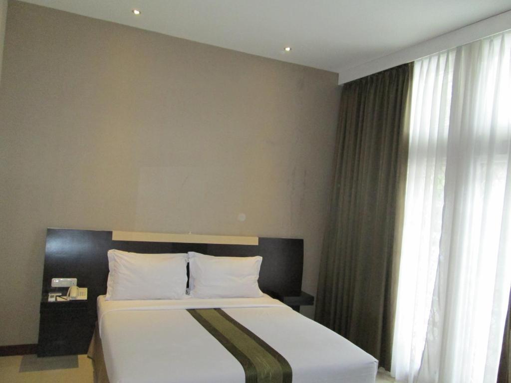 Postel nebo postele na pokoji v ubytování Vio Hotel Cimanuk Bandung