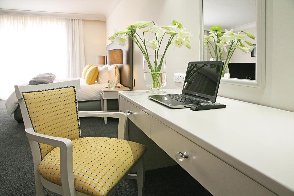 a room with a desk with a laptop and a chair at Hollow on the Square City Hotel in Cape Town