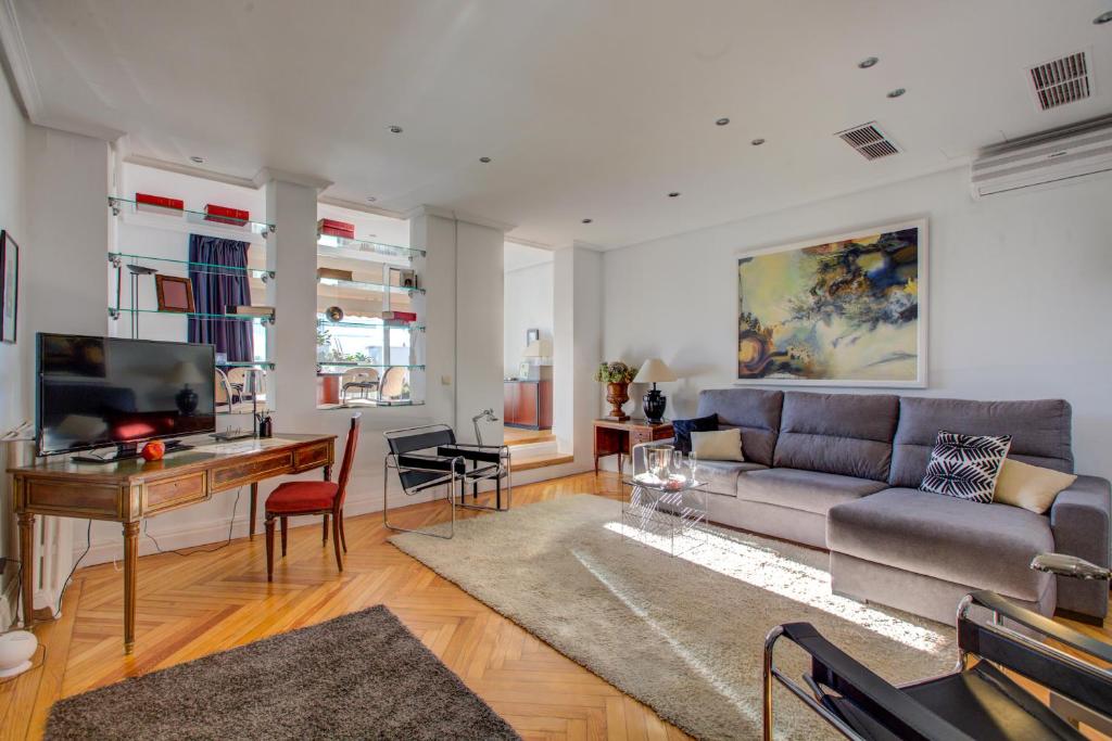 a living room with a couch and a table at UD Apartments - Central Gran Via Apartment in Madrid