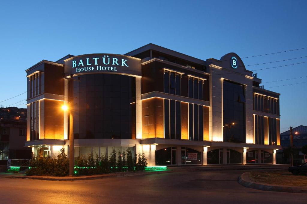 a building with a sign for a hotel at Balturk House Hotel in Kocaeli