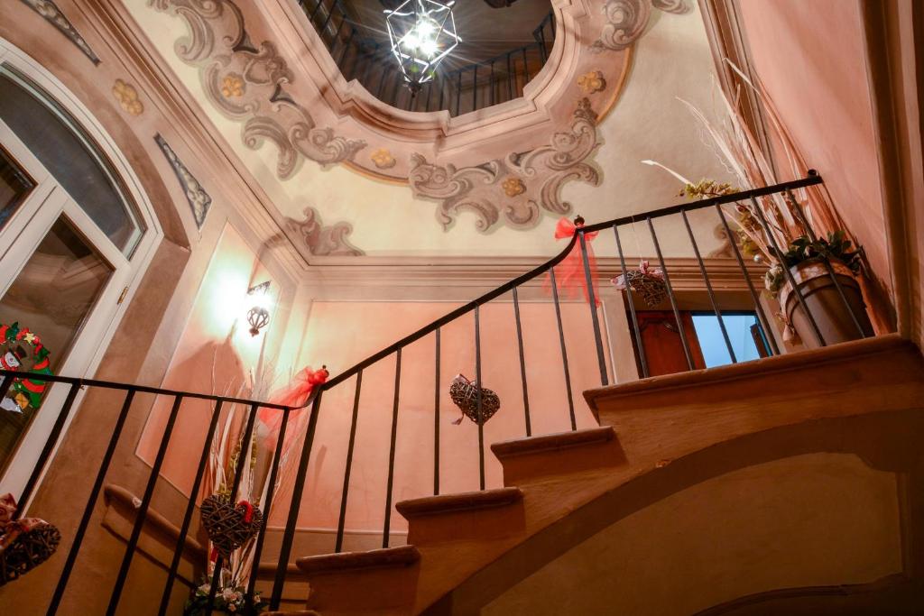 a spiral staircase in a building with a ceiling at Locanda Al Portone in Scandiano