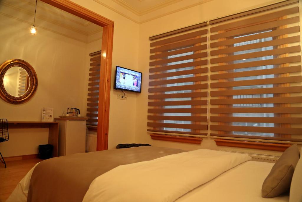 A bed or beds in a room at Belizia Hotel