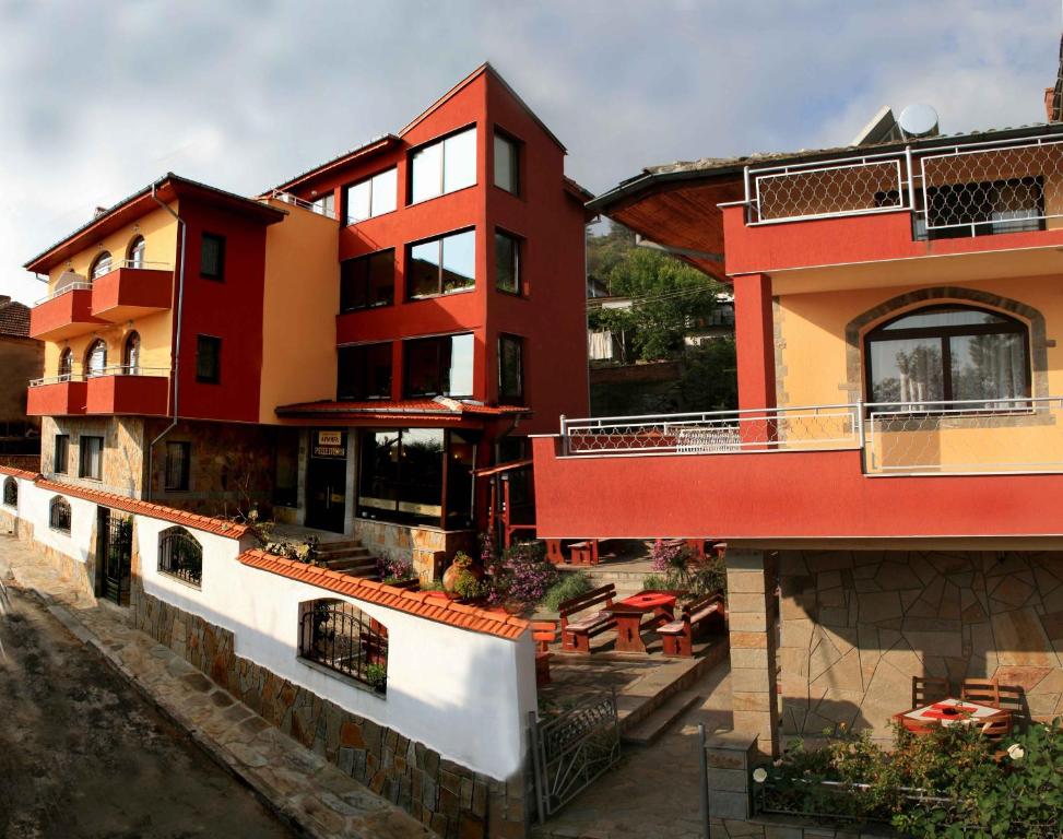 a group of buildings with red and yellow at Armira Family Hotel in Ivaylovgrad