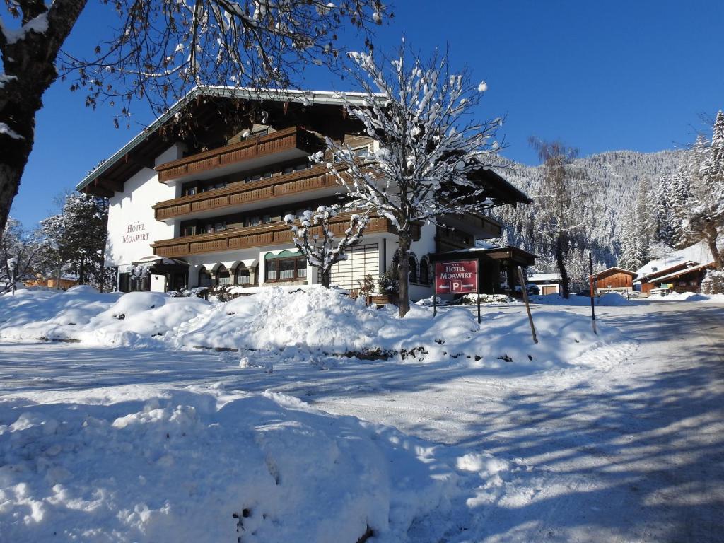 a building covered in snow in front at Hotel Moawirt in Wagrain