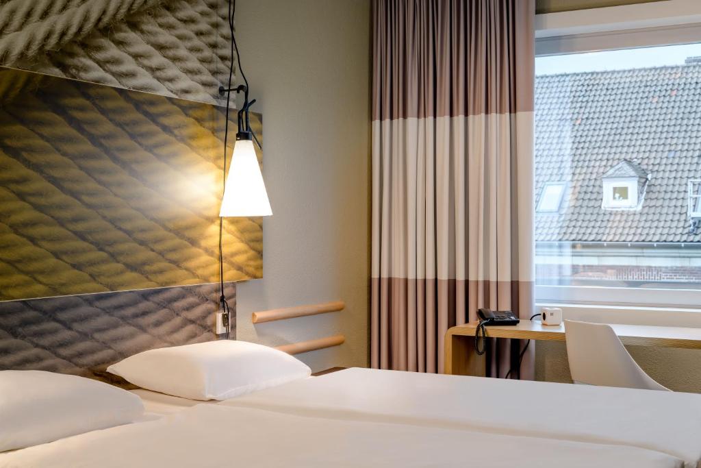 Postel nebo postele na pokoji v ubytování Ibis Münster City
