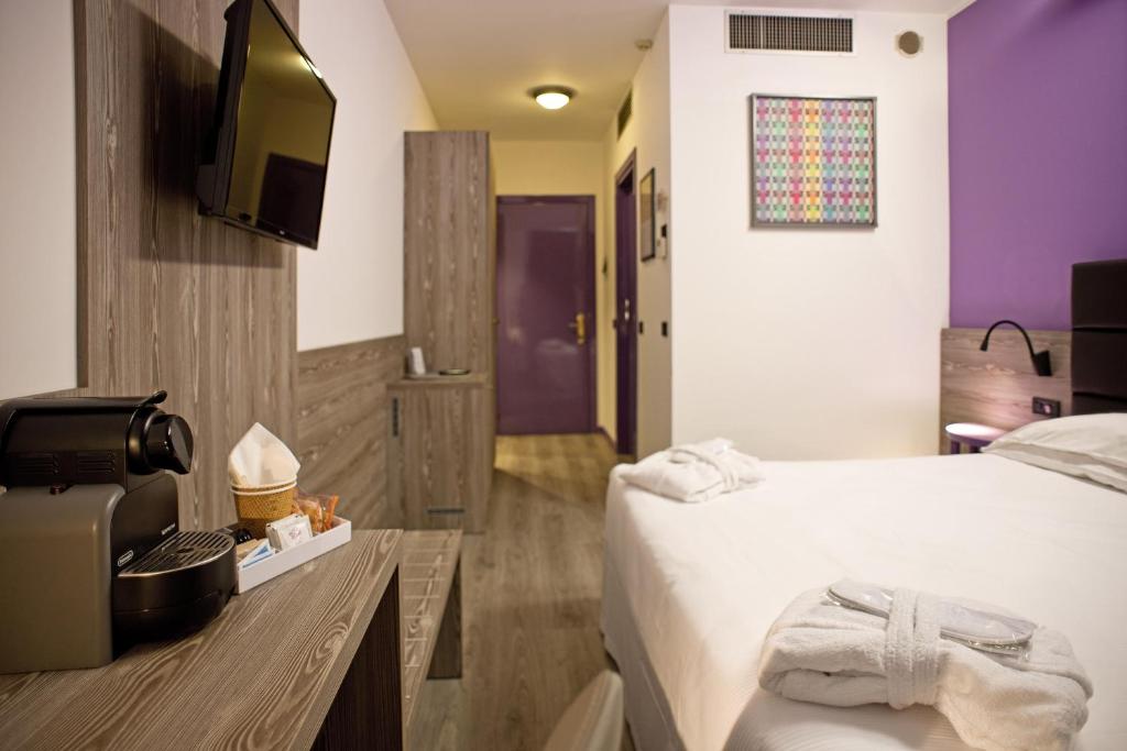 Llit o llits en una habitació de Hotel Gardenia