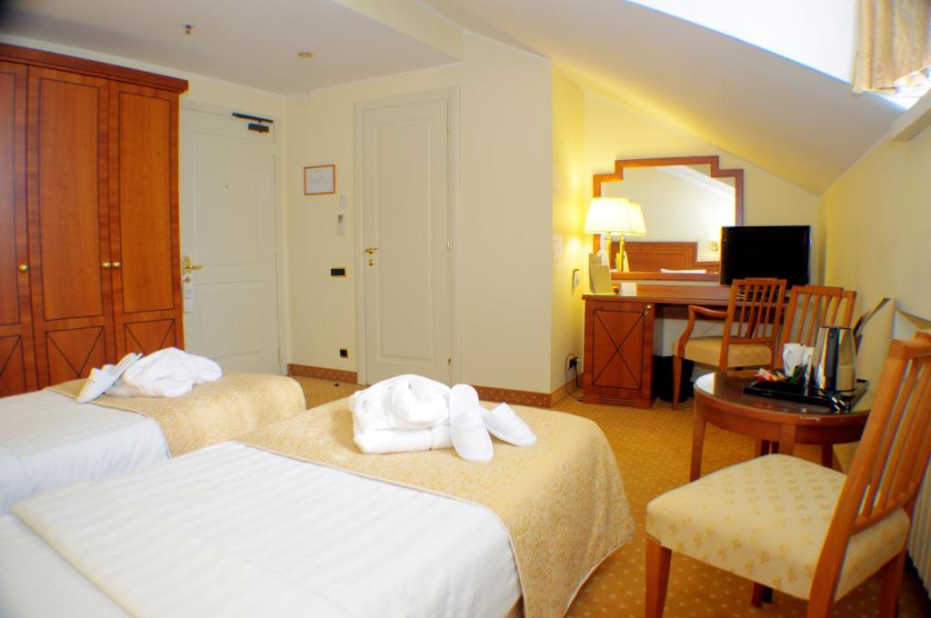 Postel nebo postele na pokoji v ubytování My City Hotel