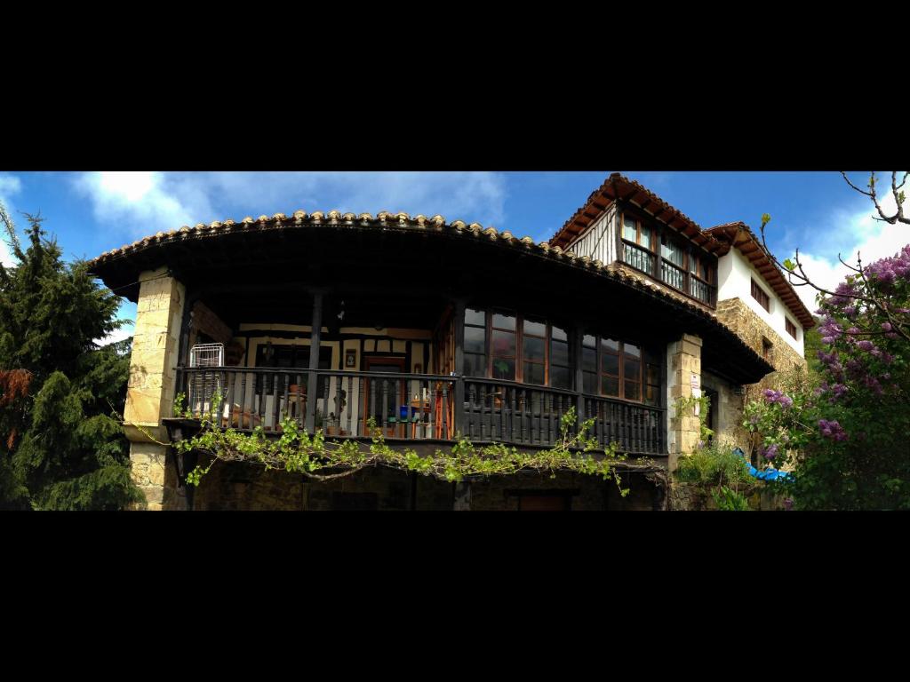 a large house with a balcony on top of it at Posada de Tollo in Tollo