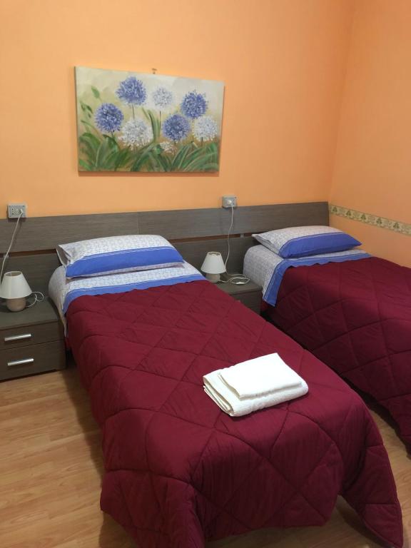 Łóżko lub łóżka w pokoju w obiekcie Locanda Beatrice