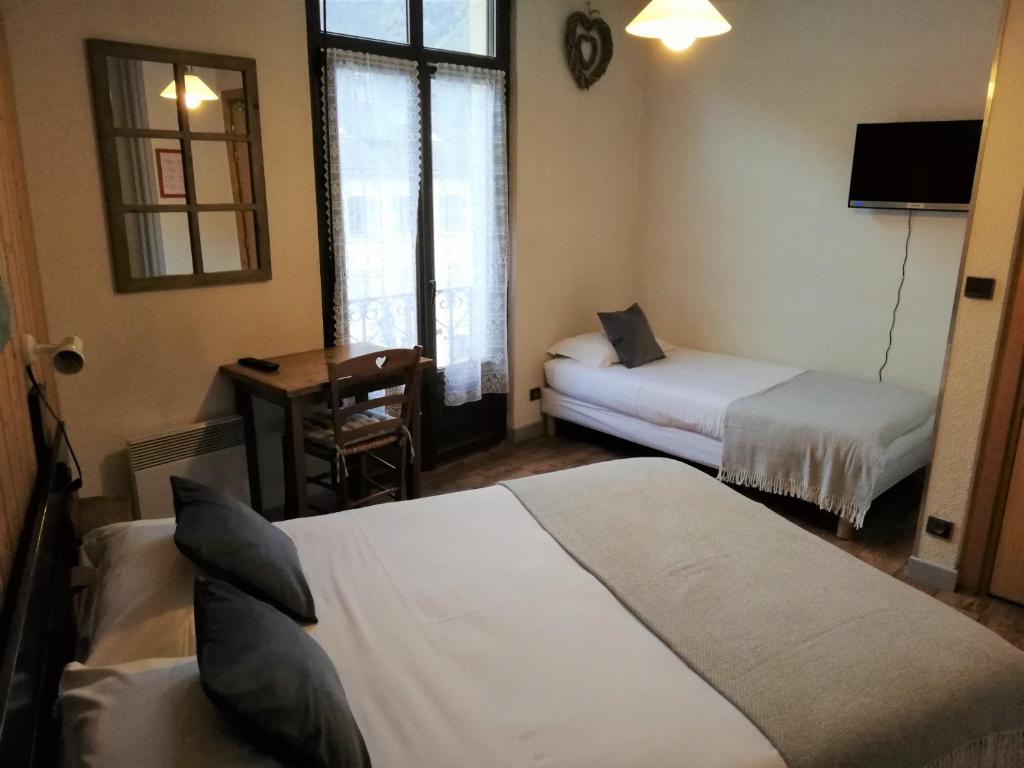 Postel nebo postele na pokoji v ubytování Terminus Hôtel des 3 Vallées