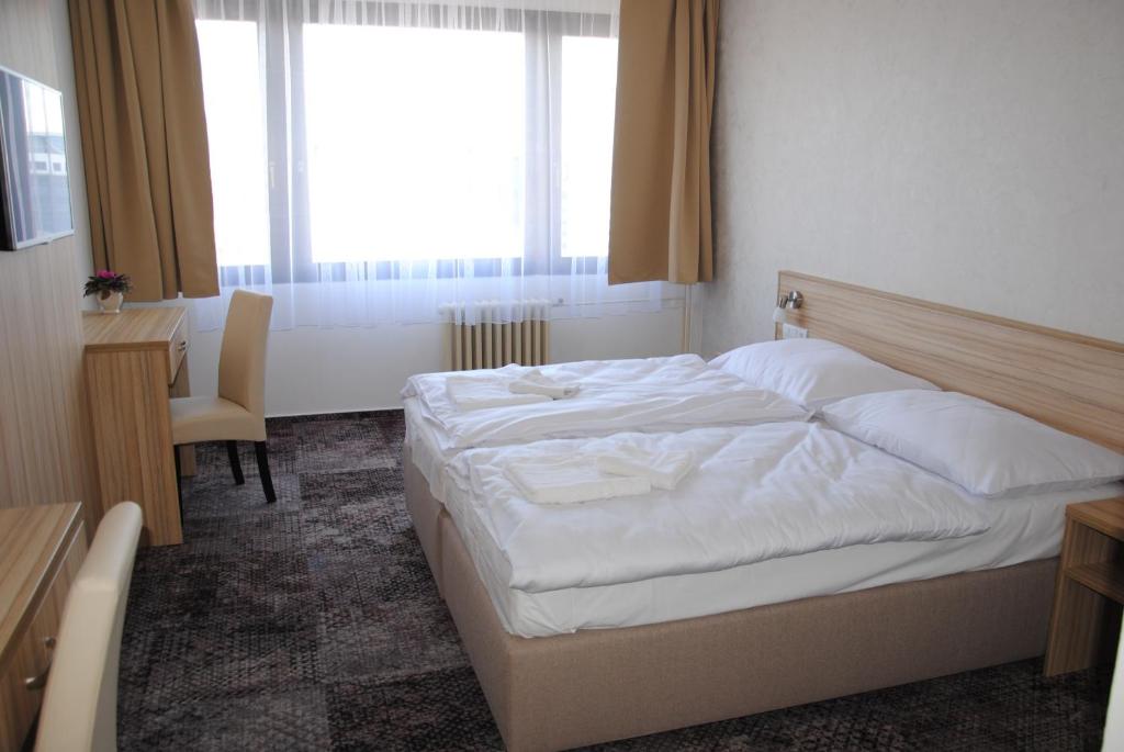 Postel nebo postele na pokoji v ubytování Hotel Labe