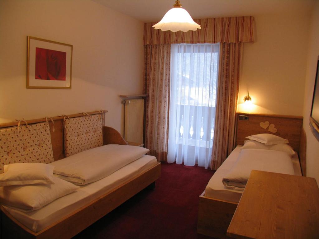 A bed or beds in a room at Hotel Reichegger