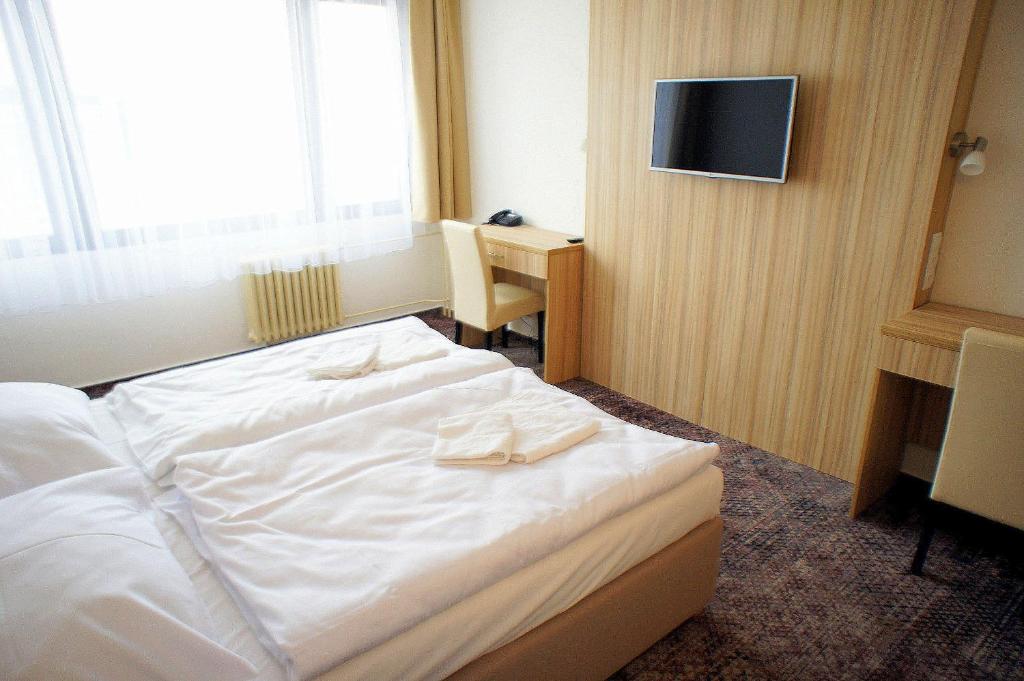 Postel nebo postele na pokoji v ubytování Hotel Labe