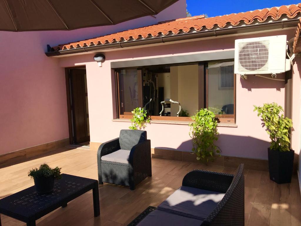 a patio with a chair and a window at Puntižela-Patty in Pula