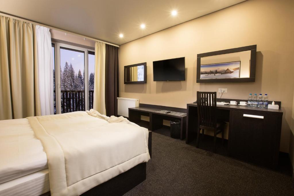 Ліжко або ліжка в номері Girski Hotel&Spa