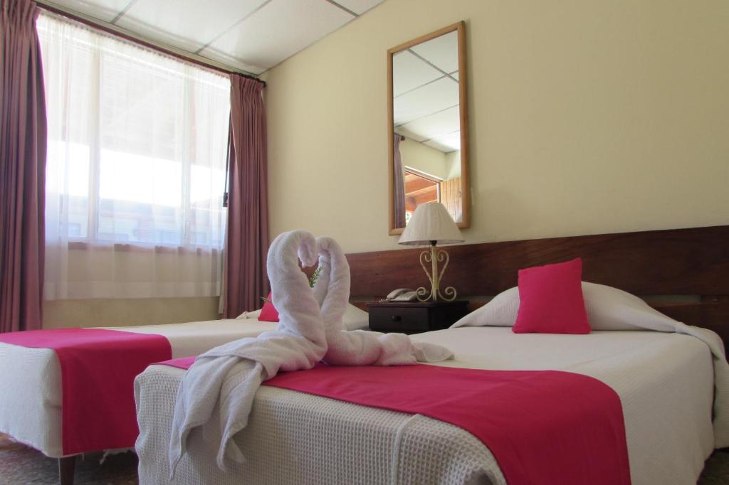 Postel nebo postele na pokoji v ubytování Hotel La Siesta