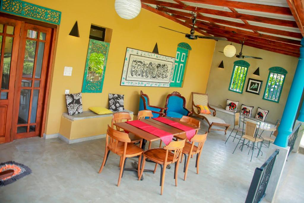 a dining room with a table and chairs at Kurumba Villas in Bentota