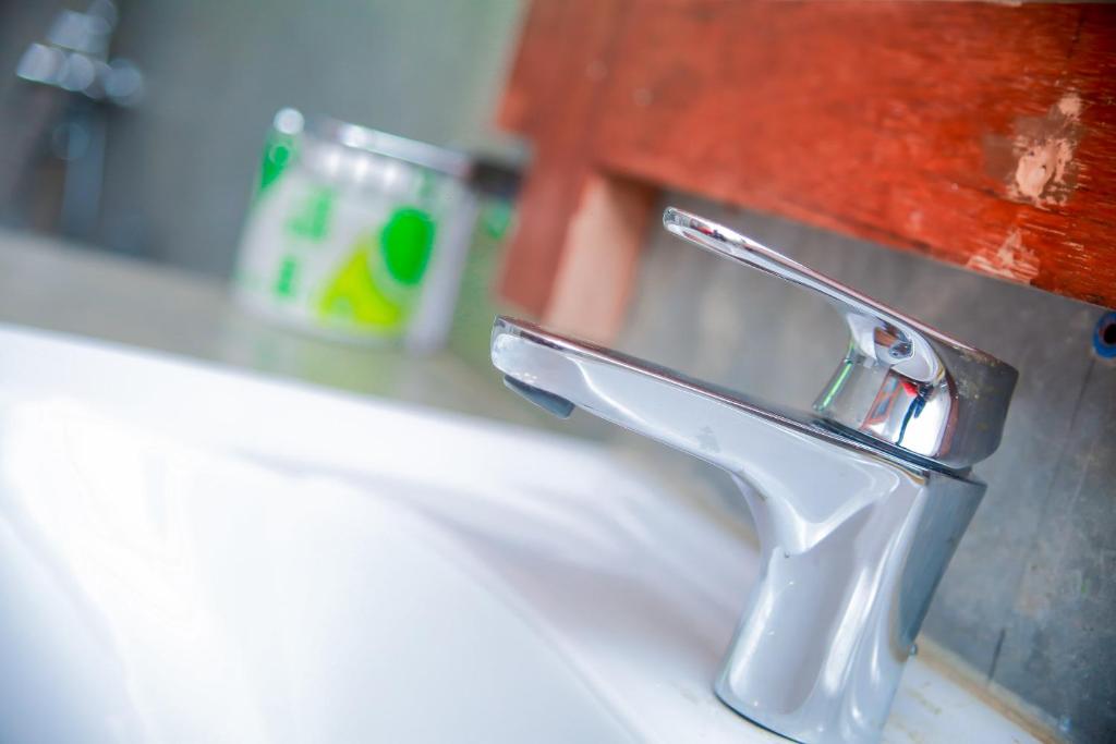 a bathroom sink with a chrome water faucet at Kurumba Villas in Bentota