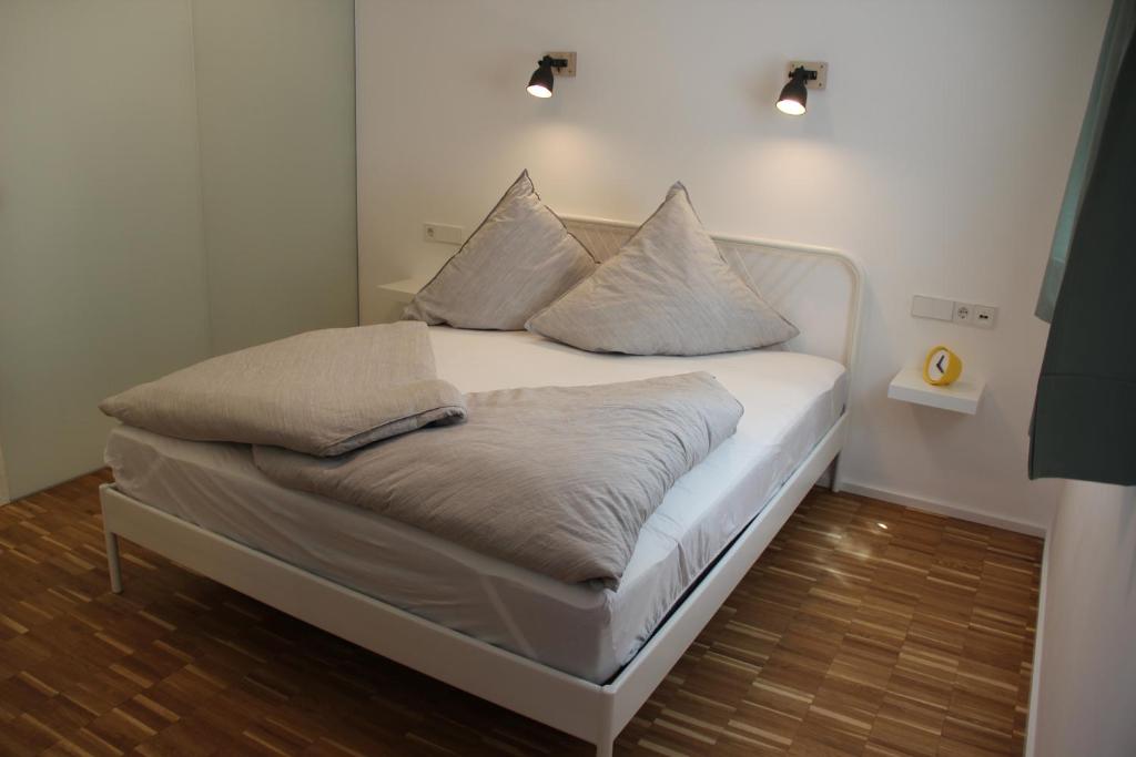 a bed with pillows on it in a room at IW6 in Meersburg