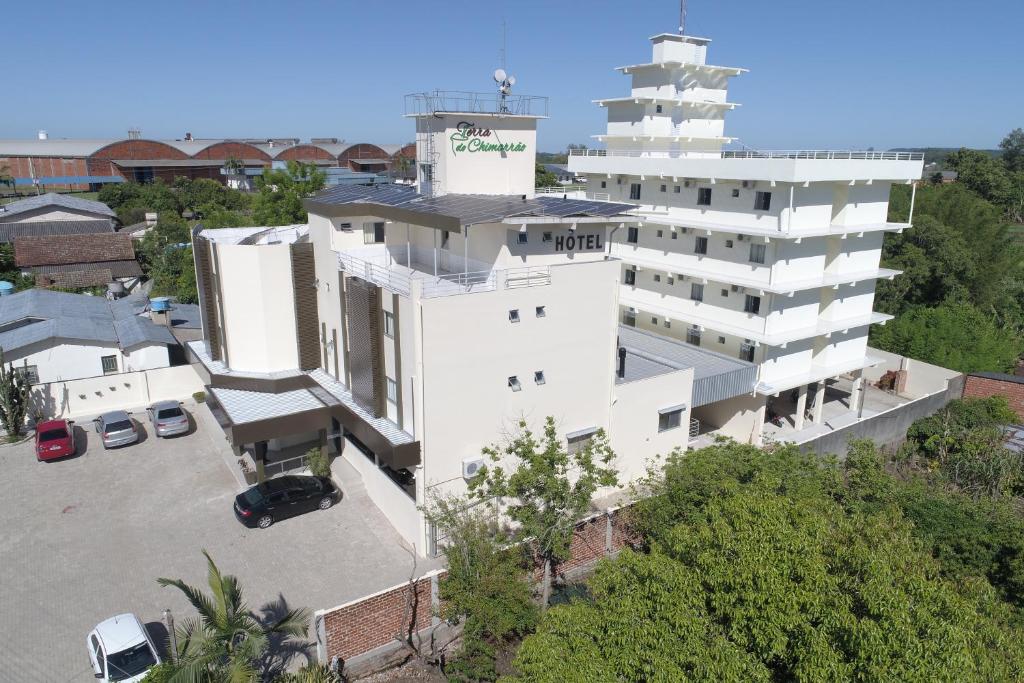 an aerial view of a white building with a tower at Terra do Chimarrão Hotel in Venâncio Aires