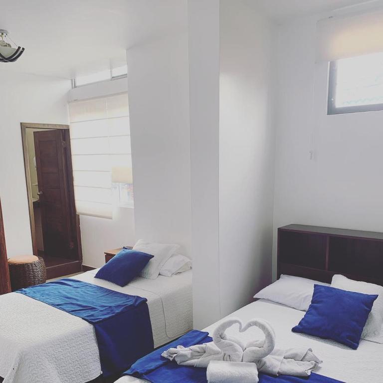Postel nebo postele na pokoji v ubytování Hostal Costa del Pacifico