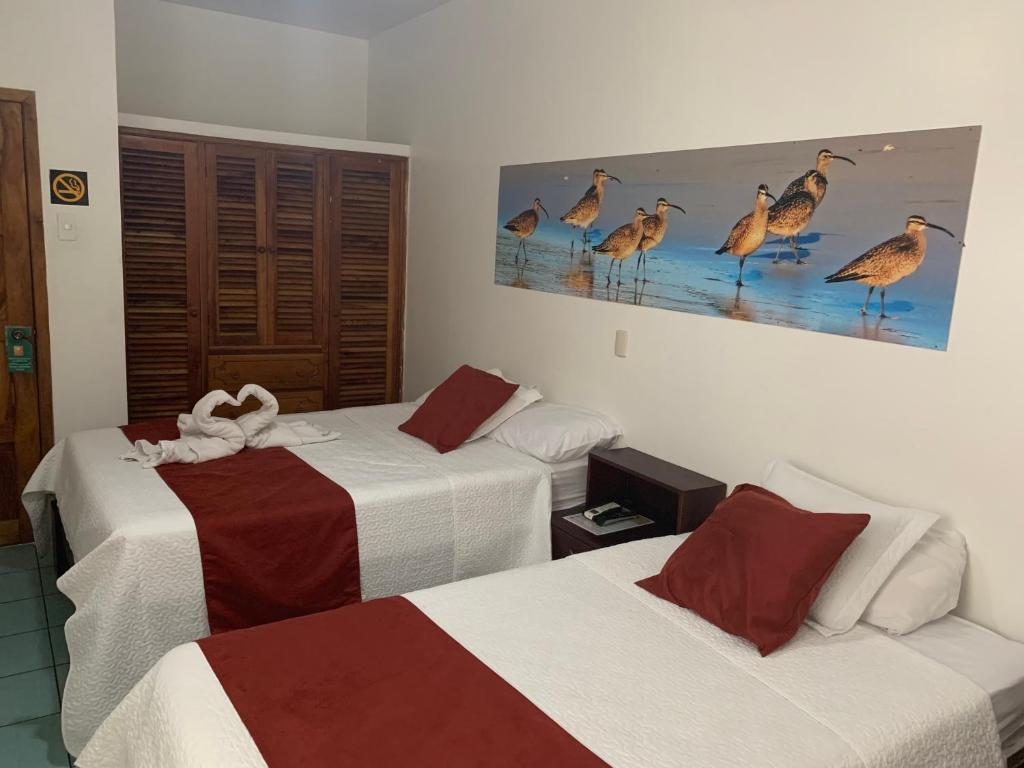Postel nebo postele na pokoji v ubytování Hostal Costa del Pacifico