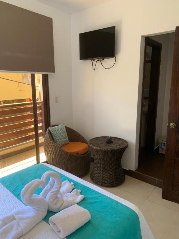 Postel nebo postele na pokoji v ubytování Hostal Costa del Pacifico