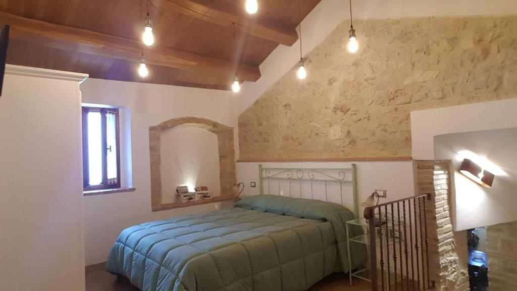En eller flere senge i et værelse på Le Tradizioni Casa Vacanze