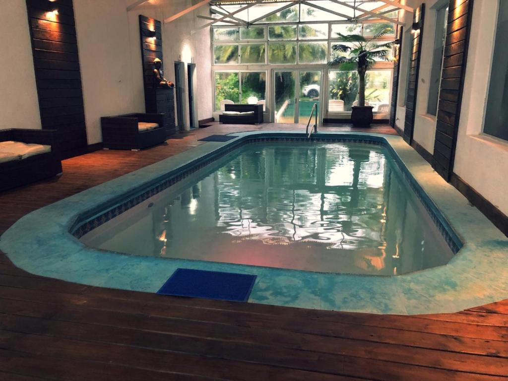 a swimming pool in the middle of a house at Hotel Select in Piriápolis