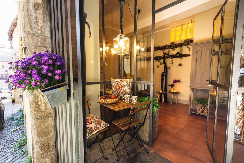 a room with a table and flowers on the wall at City Jungle in Viterbo