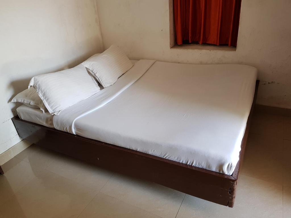 Postel nebo postele na pokoji v ubytování Hotel Gandhara