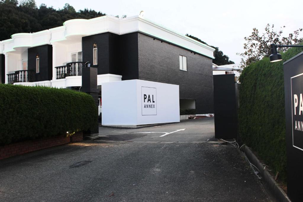 a building with a parking lot with a garage at Pal Annex Munakata (Love Hotel) in Munakata