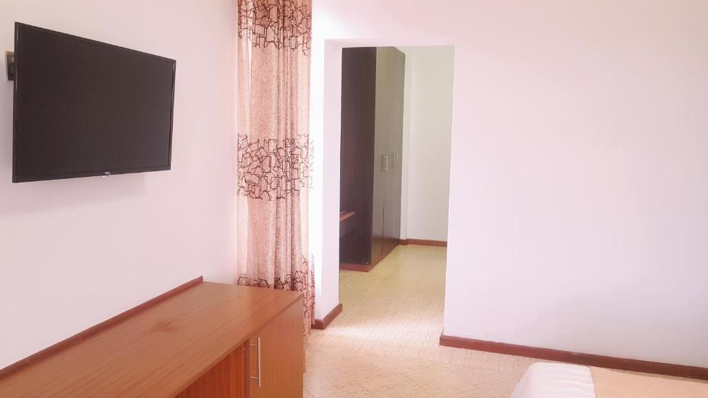 TV a/nebo společenská místnost v ubytování Grand Winston Hotel