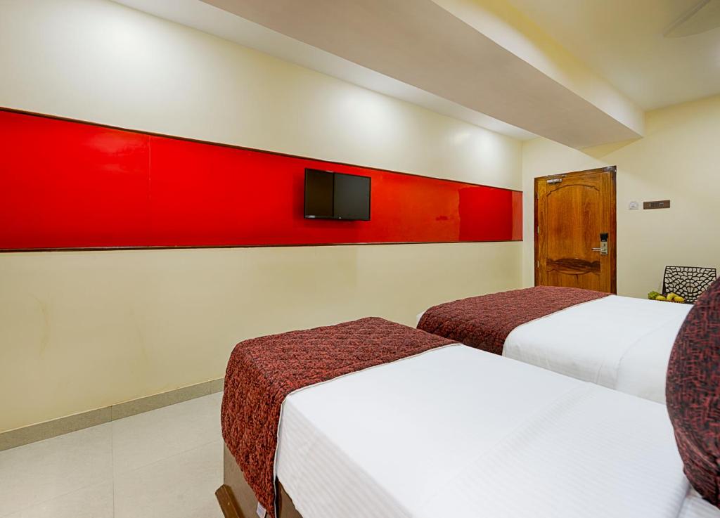 Postel nebo postele na pokoji v ubytování Hotel Ramraj Regency