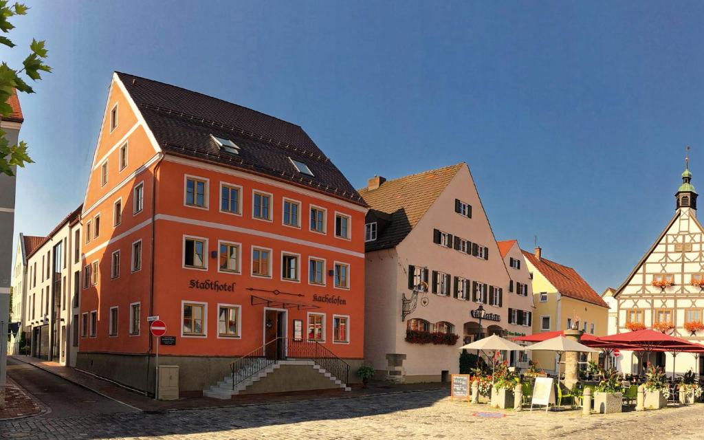 a large building with a clock on the side of it at Stadthotel Kachelofen in Krumbach