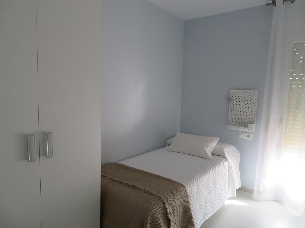 Postel nebo postele na pokoji v ubytování Alcañiz Flats II