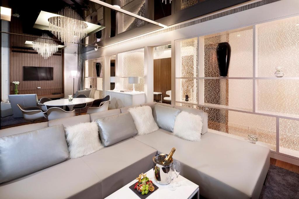 a living room with a white couch and a table at Melia Vienna in Vienna