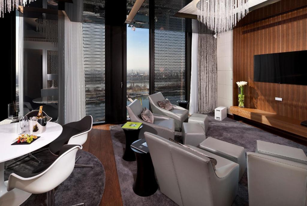a room with a table and chairs and a large window at Melia Vienna in Vienna