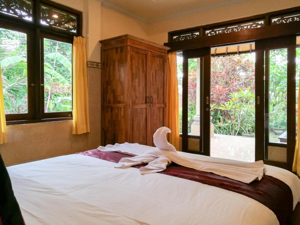 Postel nebo postele na pokoji v ubytování Mulan Dini House