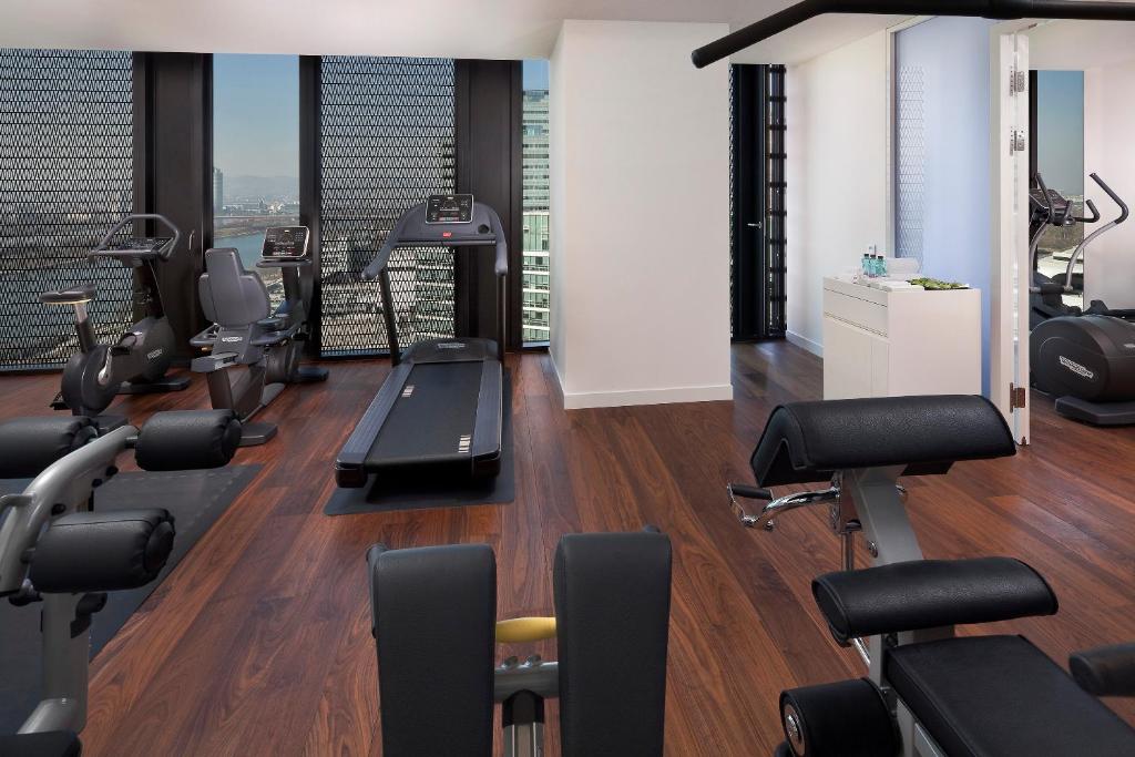 a gym with treadmills and exercise equipment in a building at Melia Vienna in Vienna