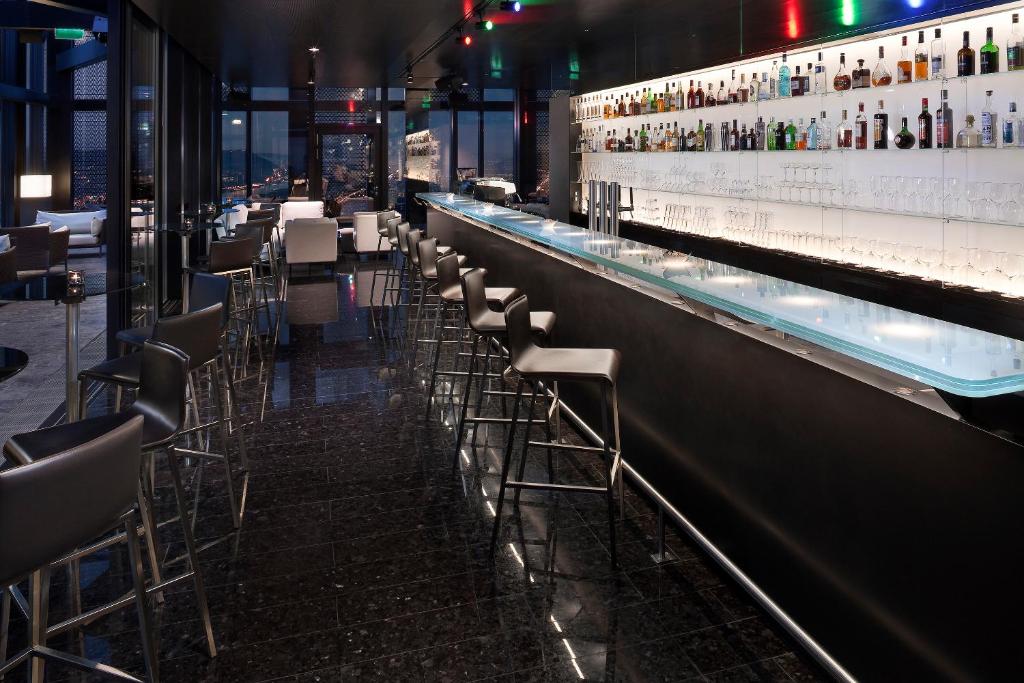 a bar with a row of chairs in a restaurant at Melia Vienna in Vienna