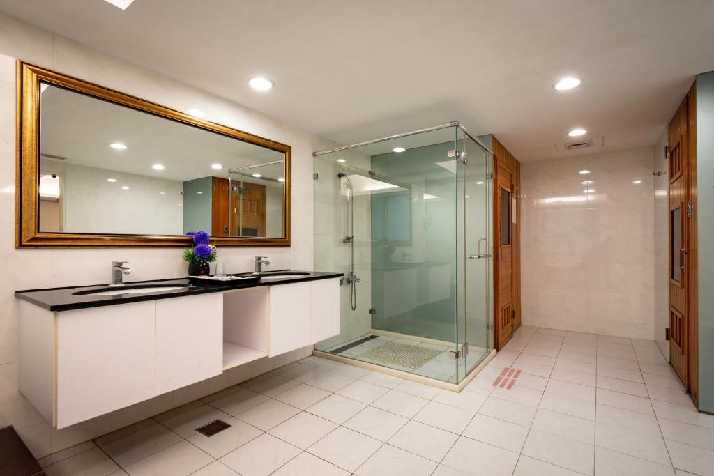 a bathroom with two sinks and a glass shower at Yoyo Hotel in Chiayi City