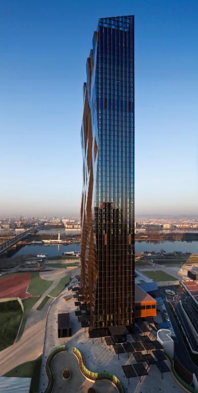 a rendering of a tall skyscraper in a city at Melia Vienna in Vienna