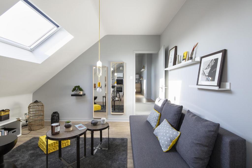 a living room with a couch and a table at Azulejo by Cocoonr in Nantes