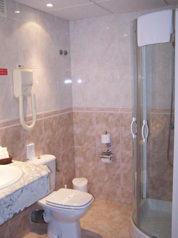 a bathroom with a shower and a toilet and a sink at Ona Princesa Playa in Marbella