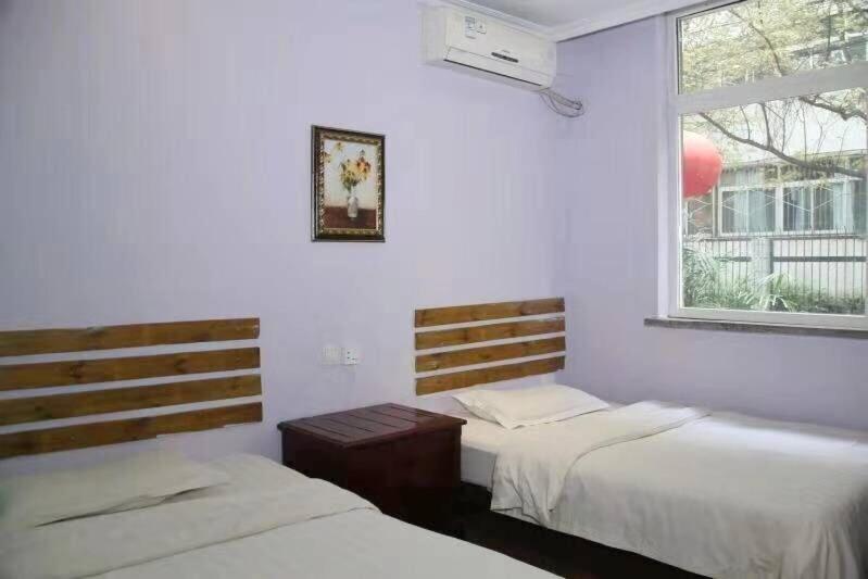 Postel nebo postele na pokoji v ubytování Xi'an The Facebook Youth Hostel