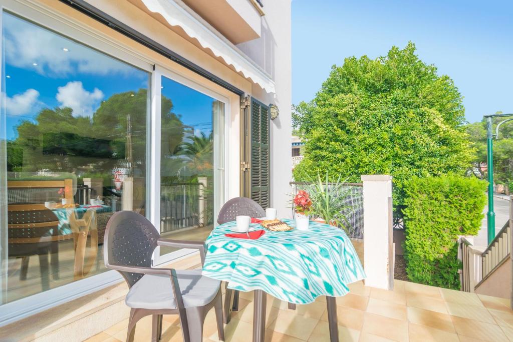 a table on a balcony with a table and chairs at Lluna Home in Colonia Sant Jordi
